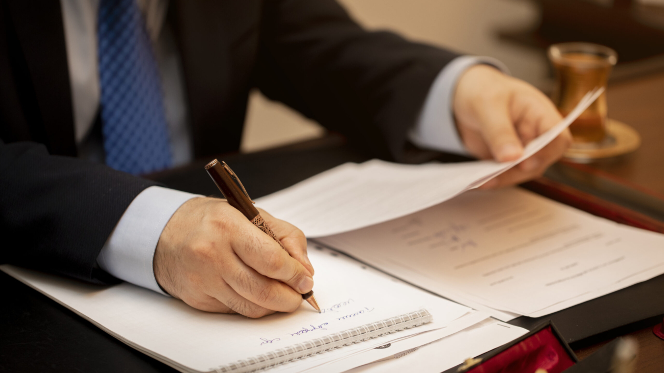 Businessman signing important contract papers. High quality photo